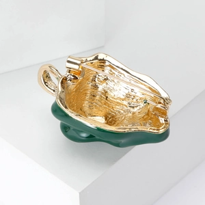 Golden pepper brooch with green enamel back view showing secure metal pin clasp