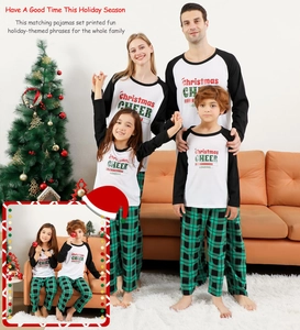 Family Christmas pajamas set with green plaid pants and holiday slogans in a cozy home