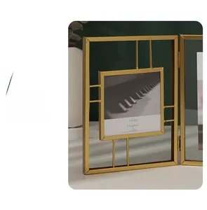 Detail of a minimalist gold metal hollow folding picture frame with 4x4 inch display size