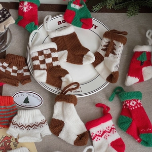 Knitted Christmas stocking ornaments in festive colors and patterns for holiday decor