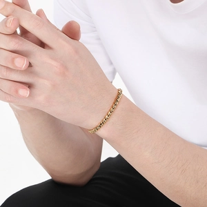 Detail shot of a men's 18k gold-plated stainless steel twisted rope chain bracelet on wrist