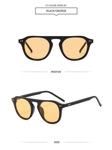 Detail view of vintage flat top sunglasses in black with orange lenses and metal rivets