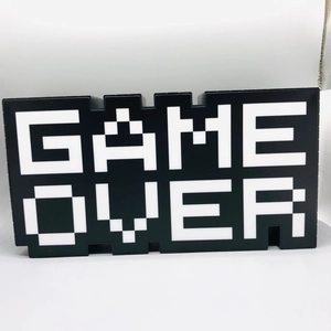 Detailed close-up of retro pixel style GAME OVER LED decorative sign for gaming rooms