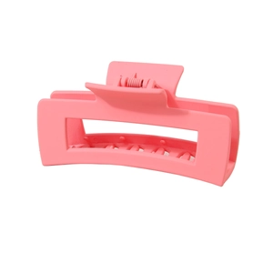 Detailed side view of a large matte pink shark hair claw clip with a strong spring