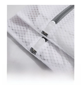 Detail showing the white mesh laundry bag with a protective elastic zipper cover design