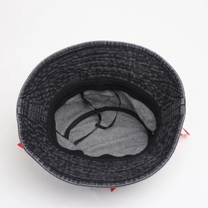 Inside view of dark grey washed denim bucket hat with black lining and adjustable wind cord