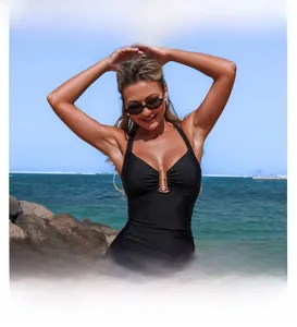 Close-up of black halter swimsuit with gold metal ring and elegant pleated details