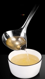 Detail of 304 stainless steel oil separator spoon with side spout and mirror finish
