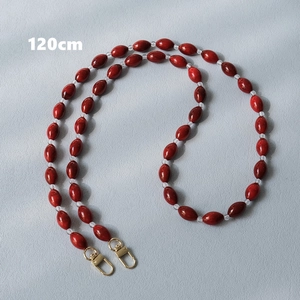 Detail of 120cm red acrylic beaded bag strap with gold metal spring buckles
