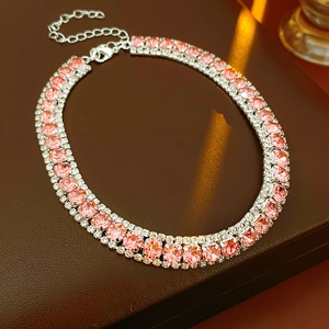 Close-up of a three-row necklace featuring pink center crystals and silver metal setting