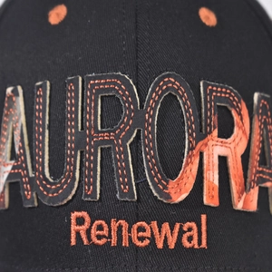 Detail of Aurora orange camo patch embroidery and Renewal text on black baseball cap
