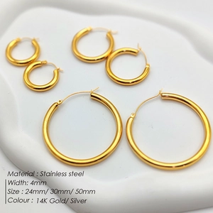Detail of 4mm stainless steel hoop earrings in 14K gold and silver with various sizes