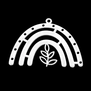Macro detail of a silver stainless steel arched pendant with leaf and branch motif