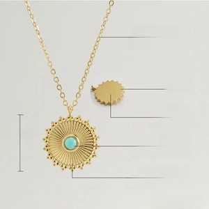 Detail of 18K gold-plated sunburst pendant with natural turquoise inlay and 450mm chain