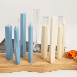 Macro detail of geometric pillar candle molds with textured blue and beige candles