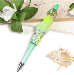 Close-up of green beaded pen with candy swirl beads and heart floral relief accents