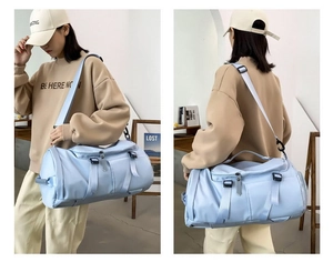 Detail of light blue nylon gym bag showing adjustable strap and buckle closure