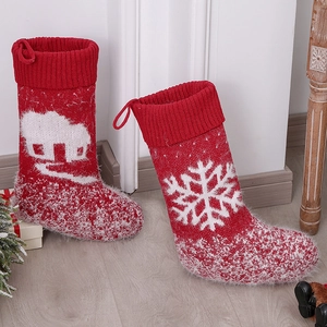 European wool knitted red Christmas stockings with white snowflake and house patterns