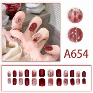 Deep burgundy and white press-on nails with rose floral patterns and silver glitter accents