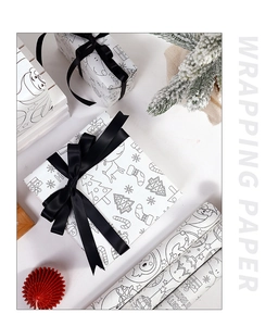 Detail of Christmas kraft wrapping paper featuring hand-drawn trees and black ribbon