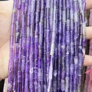Handheld view of 4x13mm cylindrical natural purple stone beads for DIY jewelry making