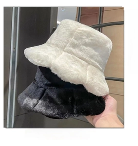 Close-up of thick faux rabbit fur textures on black and white bucket hats for winter
