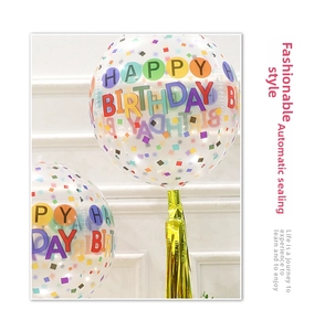 Detail of 22 inch transparent balloons with Happy Birthday print and gold tassels