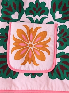 Detailed view of women's floral print cotton jacket featuring a colorful patch pocket