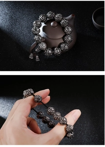 Close-up of vintage stainless steel mantra beads bracelet on ceramic and male wrist