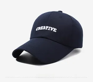 Detailed side view of navy baseball cap featuring white CREATIVE embroidery