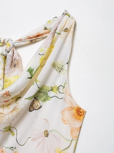 Detail of floral butterfly print chiffon dress featuring elegant shoulder tie knots