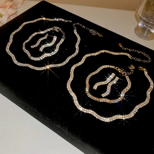 Macro detail of wave-shaped rhinestone jewelry sets with sparkling silver finish and stones