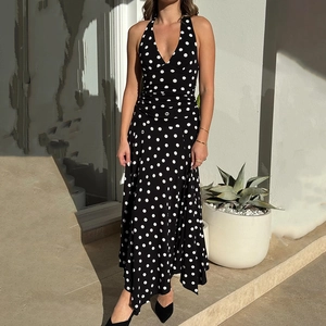 Elegant black and white polka dot halter neck maxi dress with irregular hem and v-neckline