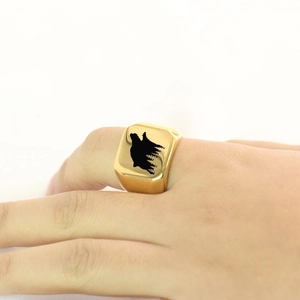 Detailed close-up of a golden square ring featuring a laser-engraved black forest and bear