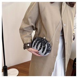 Close-up of black and silver crystal clutch bag with elegant chain strap for women