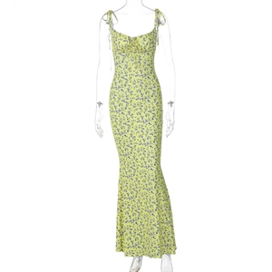 Detail view of yellow floral sundress with blue patterns and front tie design