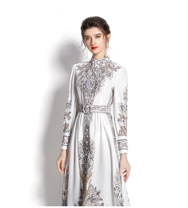 Detailed view of the vintage paisley print and fabric texture on the midi dress
