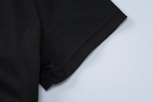 Detail view of the black dress sleeve cuff featuring precise double-stitched seams