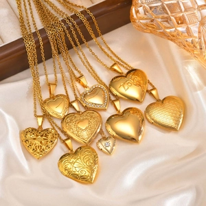 Golden heart locket necklace set in stainless steel with love engraving on silk background