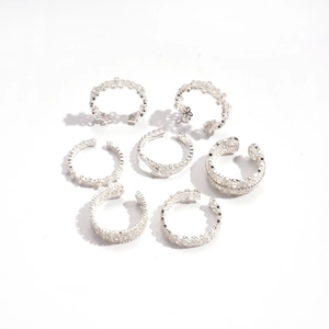 Set of seven silver open rings with hollow oval flower patterns in minimalist style