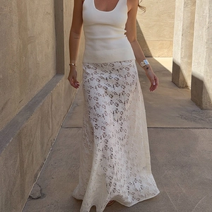 Detail view of white lace maxi skirt fabric texture and high waist transparent pattern