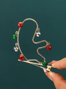 Detail of Christmas reindeer antler hair clip with colorful metallic bells on gold alloy