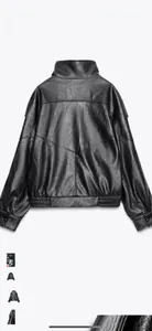 Detailed back view of a black moto jacket showing sleek faux leather texture and geometric stitching