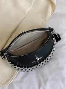 Detail view of black lychee leather crossbody bag with silver chain and chevron lining