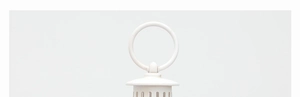 Detail of the white metal lantern top with a circular hanging ring and vented dome cap
