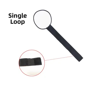 Detail view of elastic luggage strap with black rubber loop and secure velcro fastener