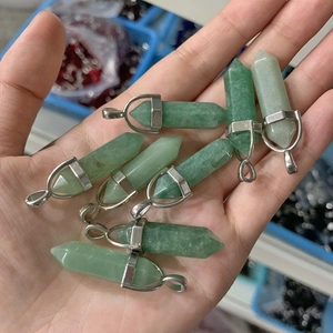 Close-up of green crystal hexagonal pillar pendants with silver metal clasps