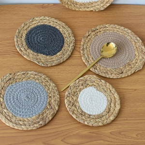 Macro view of woven placemat showing natural fiber texture and colorful fabric spiral center