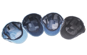 Detail of four denim newsboy caps with 100% cotton wash tags and plaid lining inside