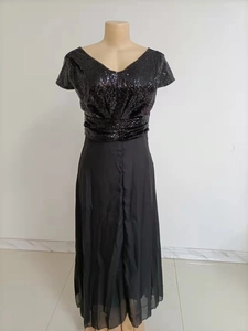 Detail of elegant V-neck sequined bodice and chiffon patchwork on black evening gown